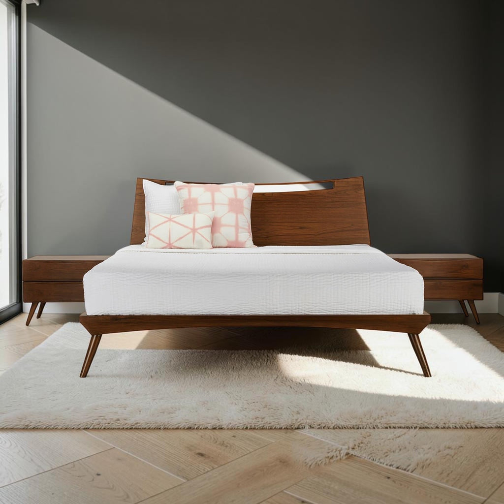 Homecrest Bickleigh mid-century modern teakwood bed frame with a sleek headboard and tapered legs in a sunlit bedroom