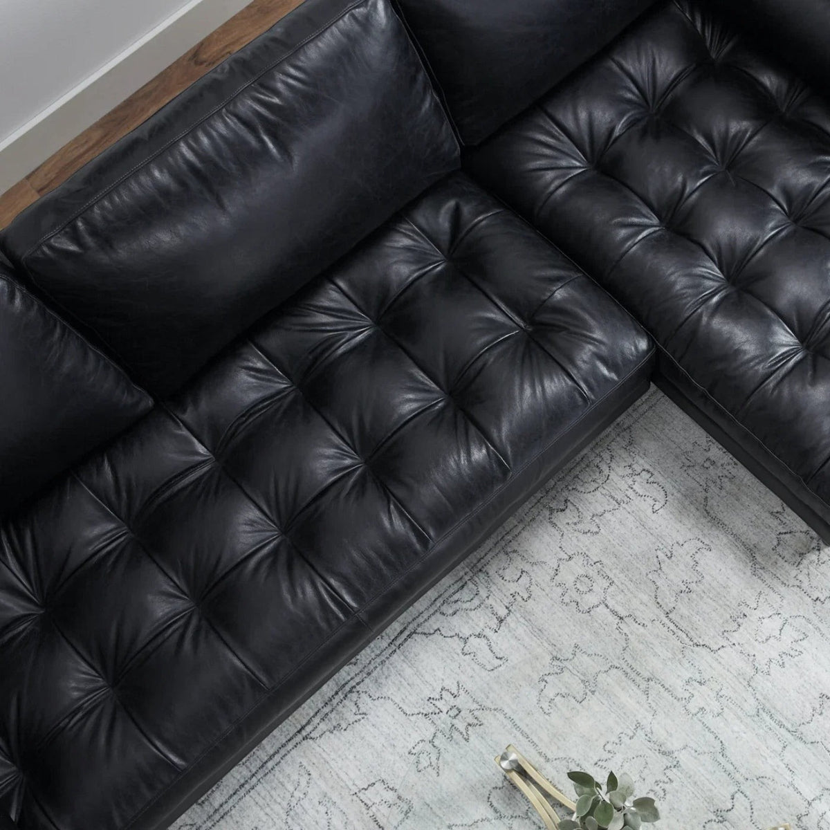 Homecrest Camber sectional sofa in black leather with a deep boxy silhouette and plush button-tufted seating