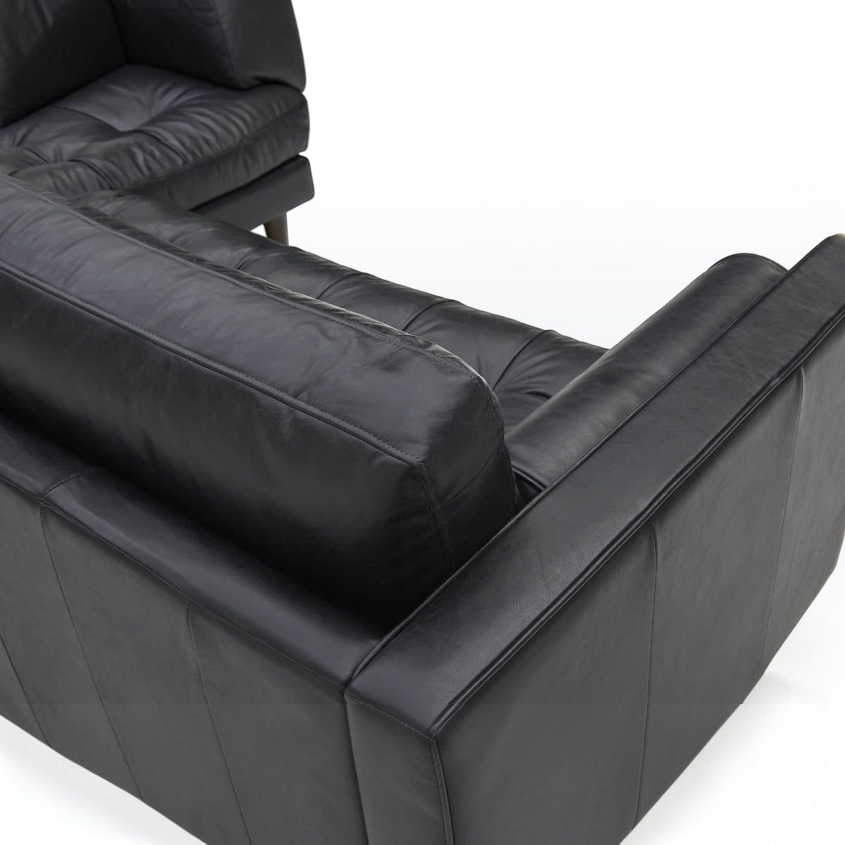 Homecrest Camber sectional sofa in Rhino Black leather with a deep boxy silhouette and button-tufted seating