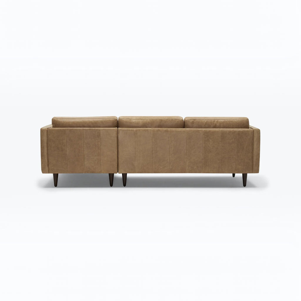 Homecrest Camber sectional sofa in camel brown leather with a boxy silhouette and tapered wooden legs, back view.