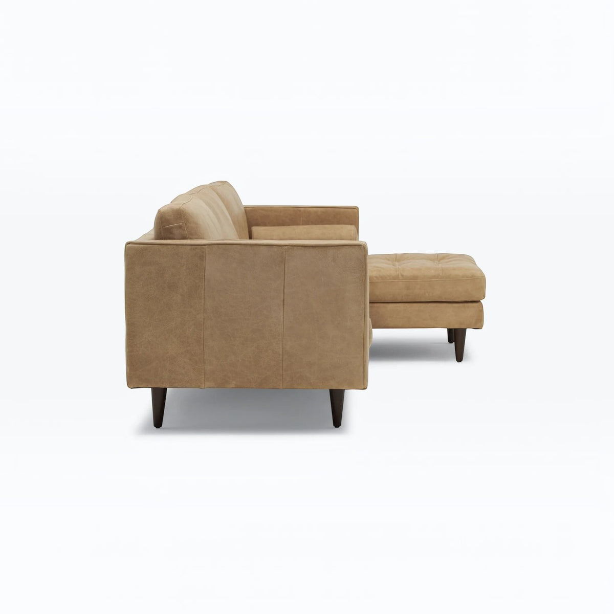 Homecrest Camber camel brown leather sectional sofa with button-tufted seating and solid wood legs, side view