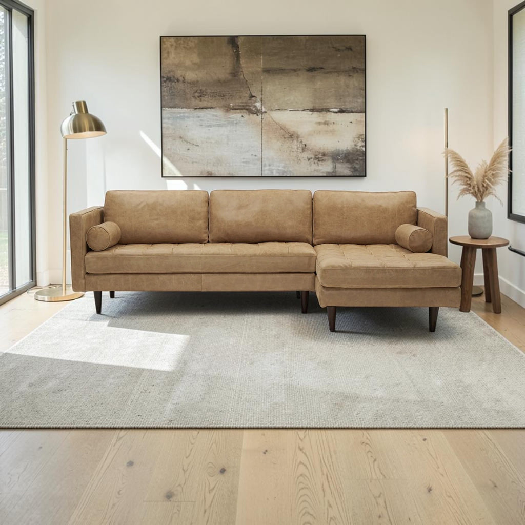 Homecrest Camber camel brown leather sectional sofa with button-tufted seating and solid wood frame in a modern room.