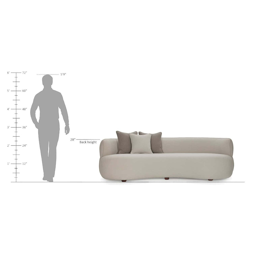 Homecrest Calla curved bean-form sofa in beige boucle fabric with teakwood legs and decorative throw cushions