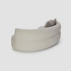 Homecrest Calla curved bean-form sofa in cream boucle fabric with a low-profile sweeping silhouette and back cushions.