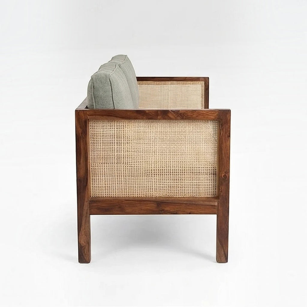 Homecrest 2-seater sofa in walnut finish with natural cane side panels and soft green upholstered cushions