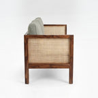 Homecrest 2-seater sofa in walnut finish with natural cane side panels and soft green upholstered cushions