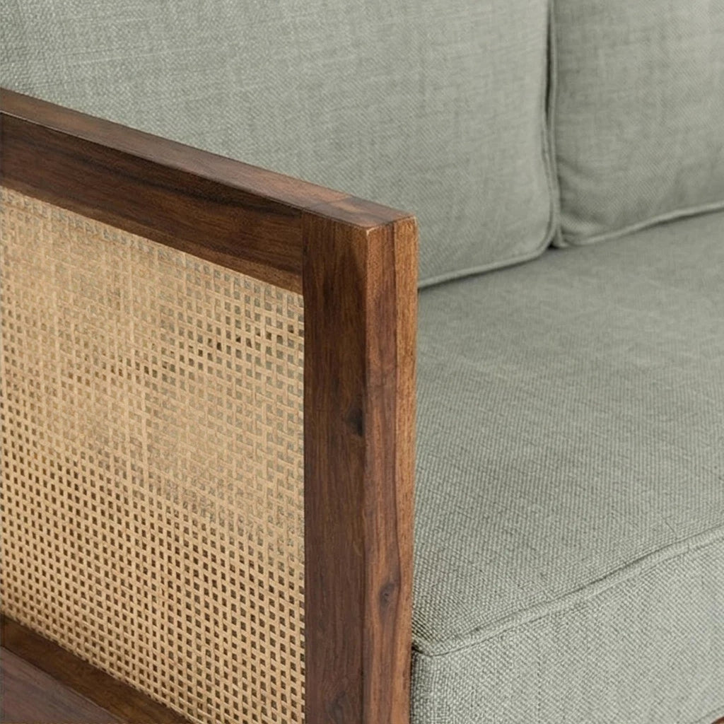 Homecrest 2-seater sofa with walnut wood frame, woven cane side panels, and sage green fabric upholstered cushions.