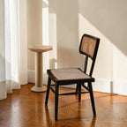 Homecrest mid-century modern dining chair in charcoal black teak wood with a hand-woven rattan wicker backrest.