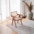 Homecrest Cavendish accent chair in natural teak wood with a woven rattan cane seat and backrest in a bright living room.