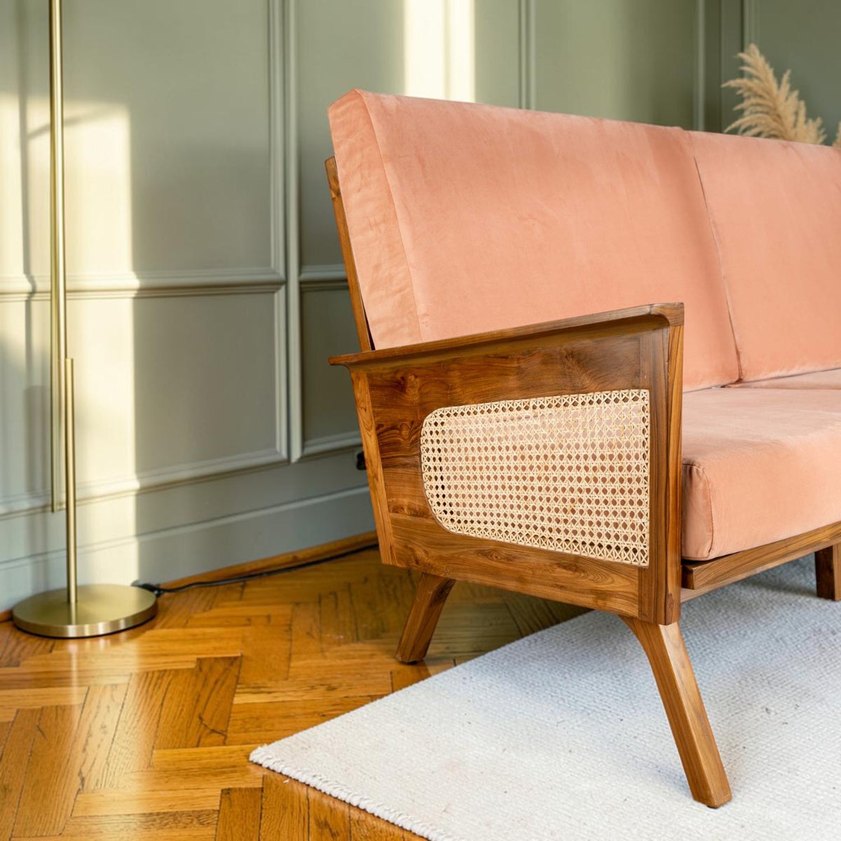 Homecrest Culworth mid-century sofa with a solid teak wood frame, cane side panels, and soft peach velvet upholstery.