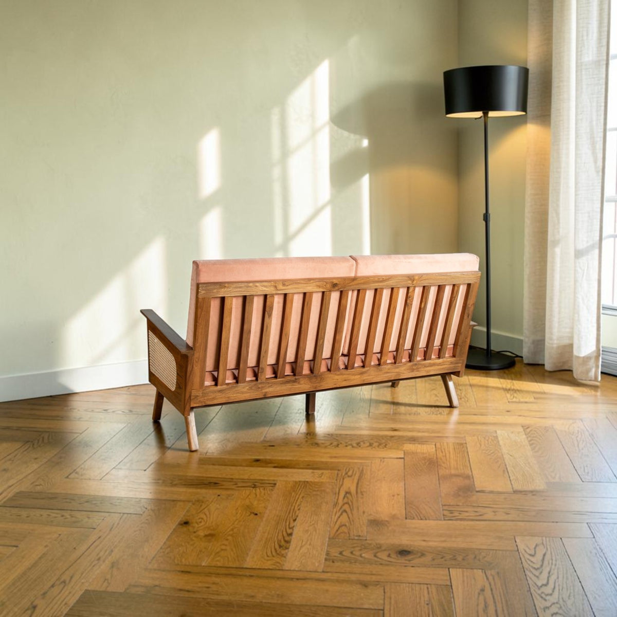 Homecrest Culworth slim mid-century sofa with a solid teak wood frame and pink upholstery in a sunlit living room