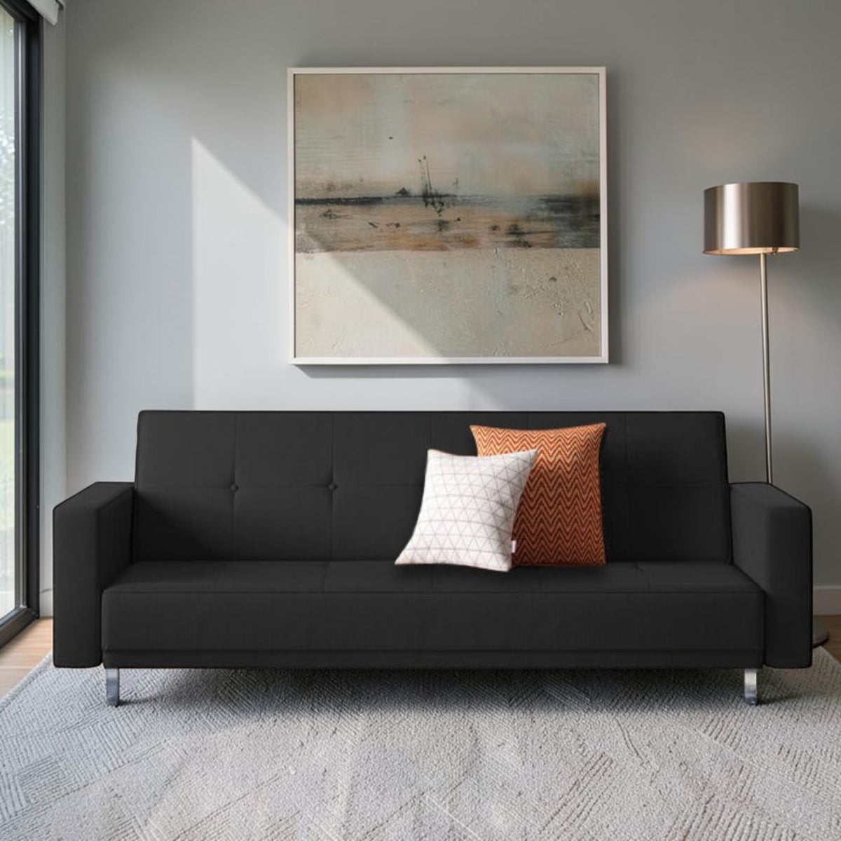 Homecrest Corbett black leatherette three-seater sofa cum bed with decorative cushions in a modern living room