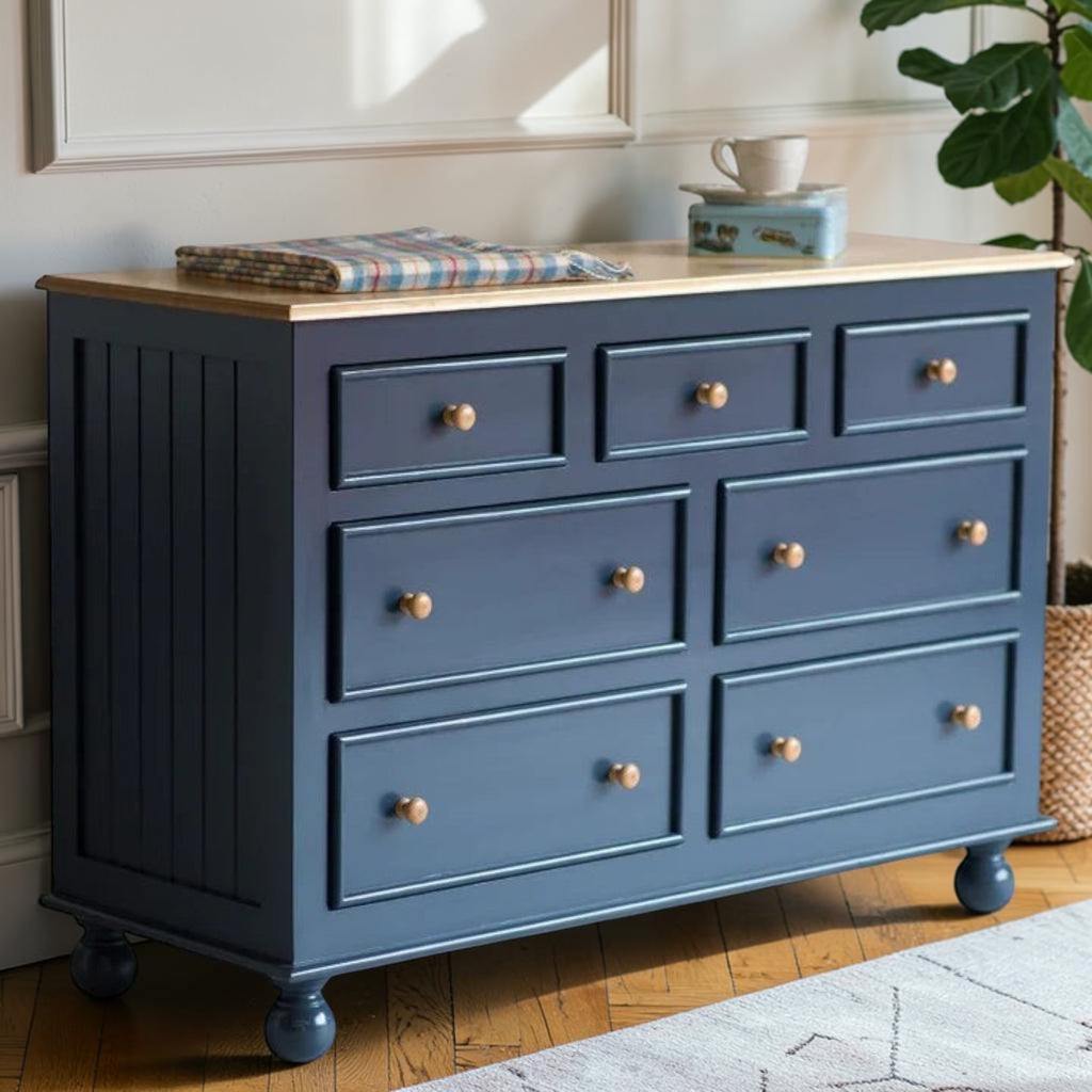 Homecrest Corin wide lowboy chest in blue with framed drawer fronts, natural wood top, and curved bun feet.