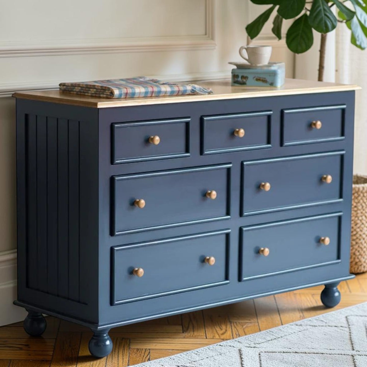 Homecrest Corin wide lowboy chest in dark blue painted finish with solid mango wood top and rustic wooden knobs.