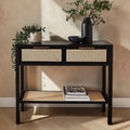 Homecrest Corvin black mango wood console table with two rattan cane drawers and a lower storage shelf