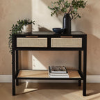 Homecrest Corvin black mango wood console table with two rattan cane drawers and a lower storage shelf