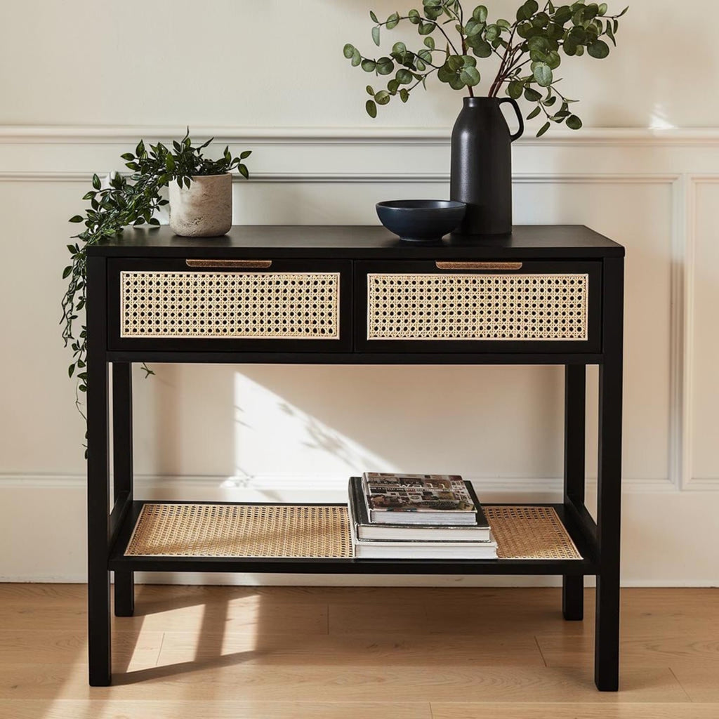 Homecrest Corvin black mango wood console table with two rattan cane drawers and a lower storage shelf