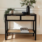 Homecrest Corvin black mango wood console table with two rattan cane drawers and a lower storage shelf