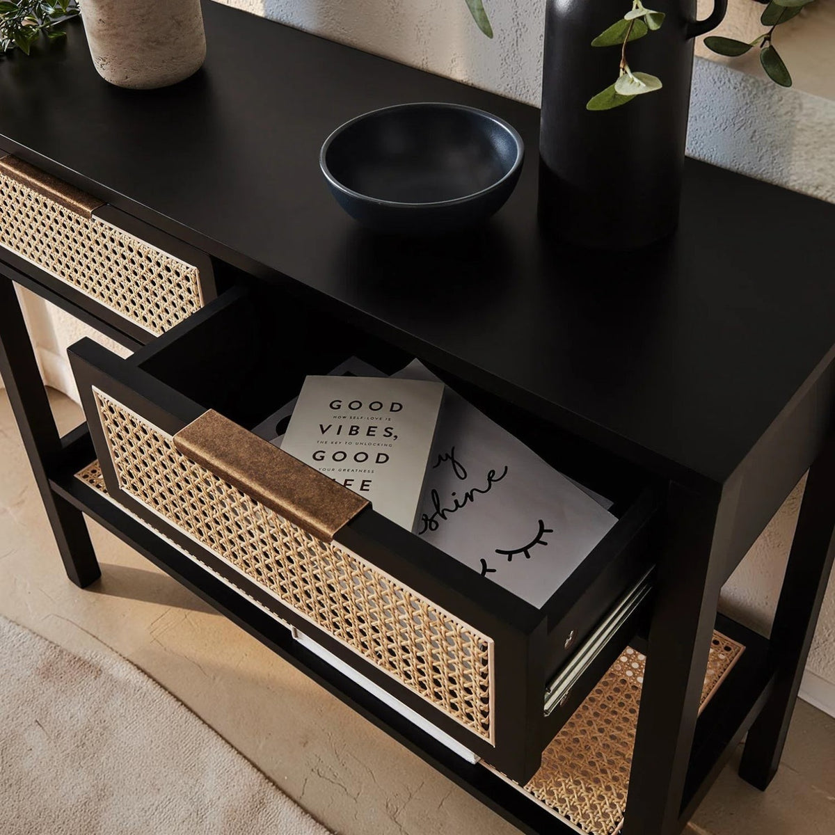 Homecrest Corvin console table in black mango wood with rattan cane drawer fronts and a modern profile handle.