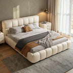 Homecrest cream velvet upholstered platform bed with a tufted headboard and footboard in a modern bedroom setting.