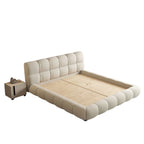 Homecrest cream velvet upholstered platform bed with a tufted headboard and matching footboard beside a nightstand.