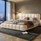 Homecrest cream velvet upholstered platform bed with a tufted headboard and footboard in a modern bedroom setting.