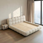 Homecrest cream velvet upholstered platform bed featuring a tufted headboard and footboard in a modern bedroom.