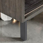 Close-up of the dark brown mango wood base and sturdy metal leg of the Homecrest Dara open bookshelf.