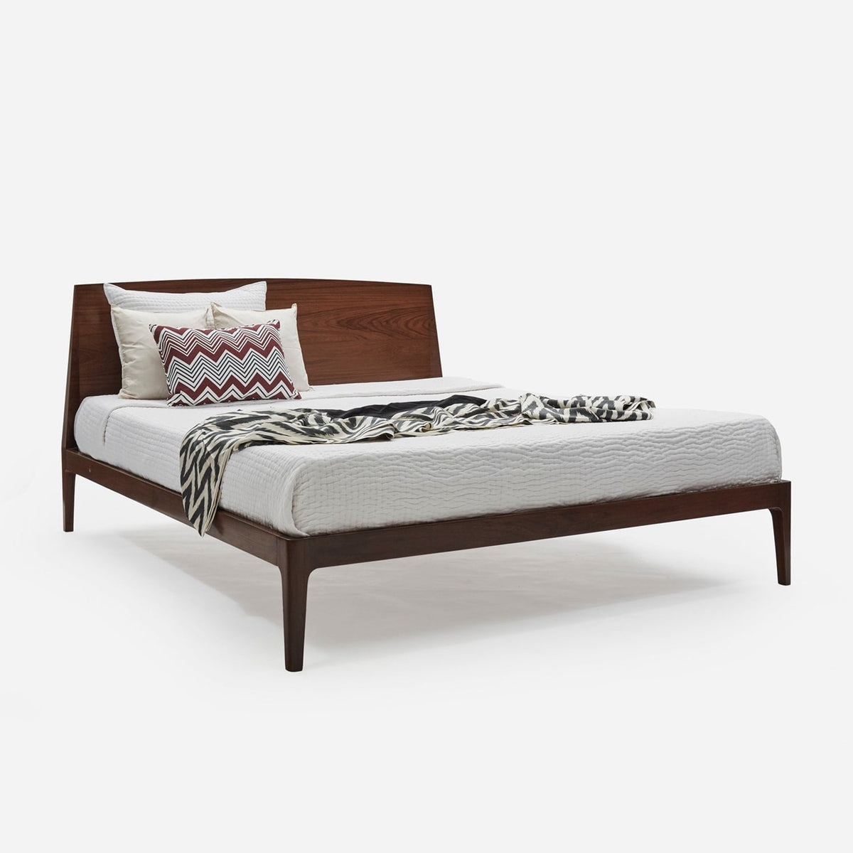 Homecrest Dunsford modern teakwood bed with a sleek chamfered edge headboard and dark wood finish in a bedroom setting.