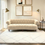Homecrest Dunmore Chesterfield sofa in beige velvet with tufted back and nailhead trim in a modern living room setting.