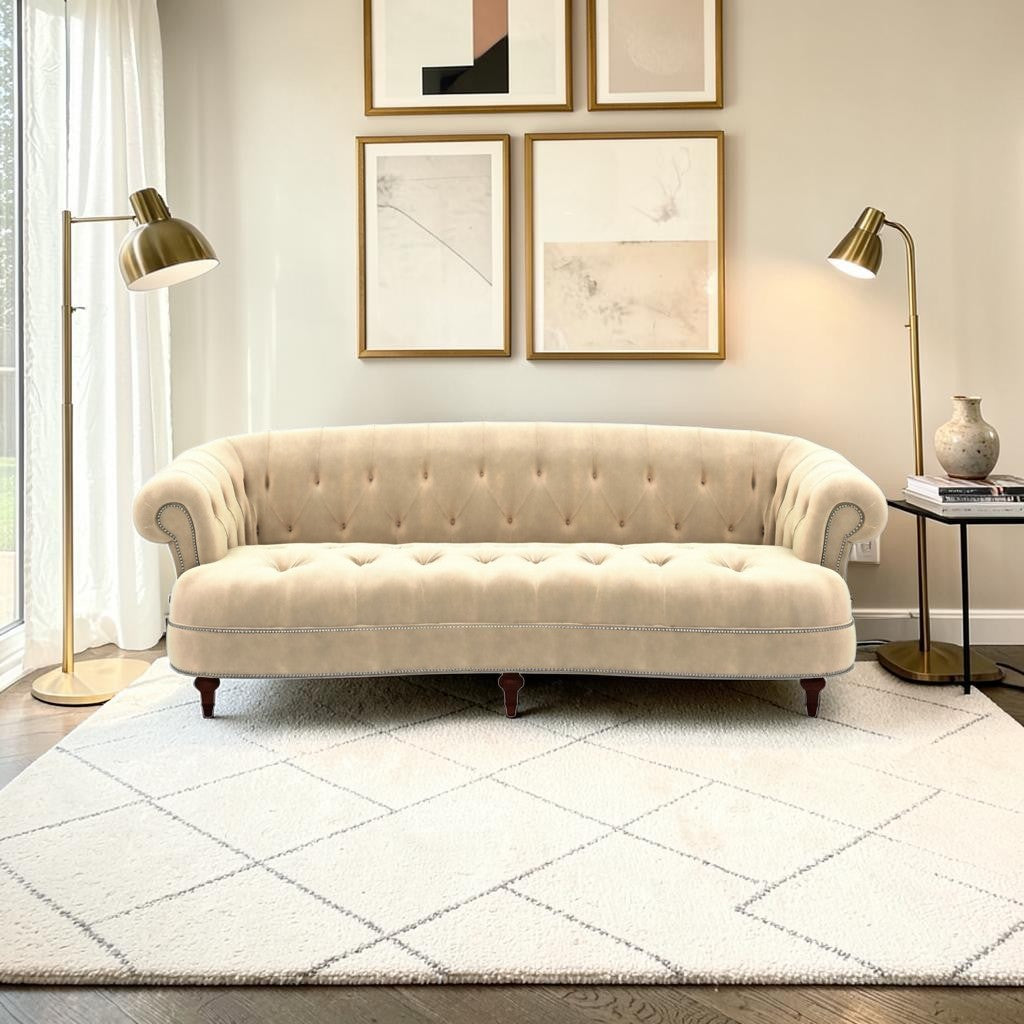 Homecrest Dunmore Chesterfield sofa in beige velvet with tufted back and nailhead trim in a modern living room setting.