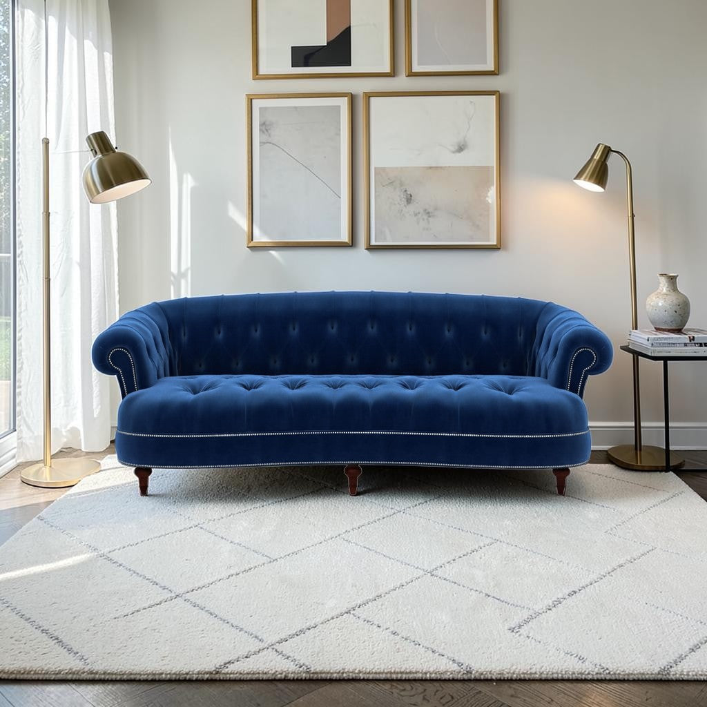 Homecrest Dunmore Chesterfield sofa in indigo blue velvet with button tufting and nailhead trim in a modern living room