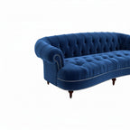 Homecrest Dunmore Chesterfield sofa in indigo blue velvet with button tufting and nailhead trim on a white background