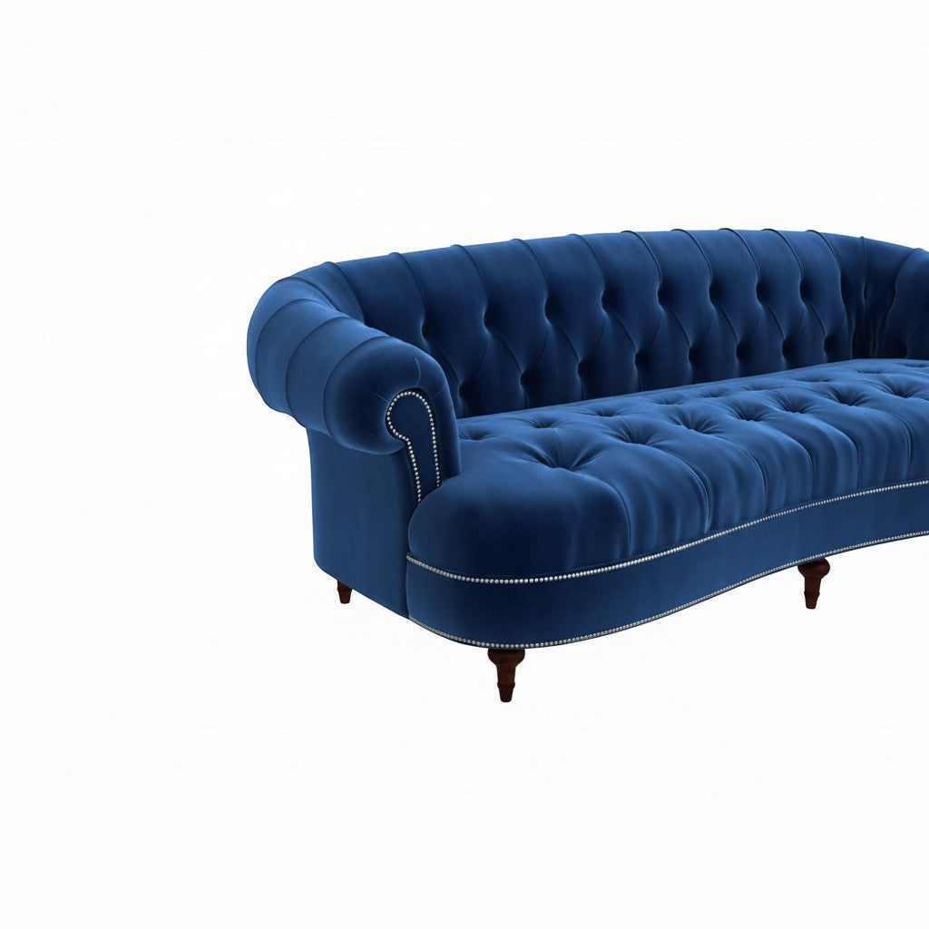 Homecrest Dunmore Chesterfield sofa in indigo blue velvet with button tufting and nailhead trim on a white background