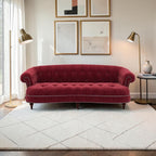Homecrest Dunmore Chesterfield sofa in pomegranate velvet with tufted back and silver nailhead trim in a living room.