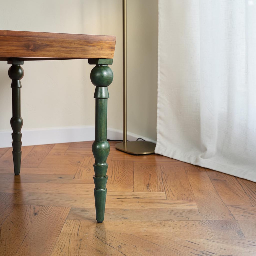 Homecrest Ellis teak dining table with natural wood top and decorative teal painted turned legs on parquet flooring.