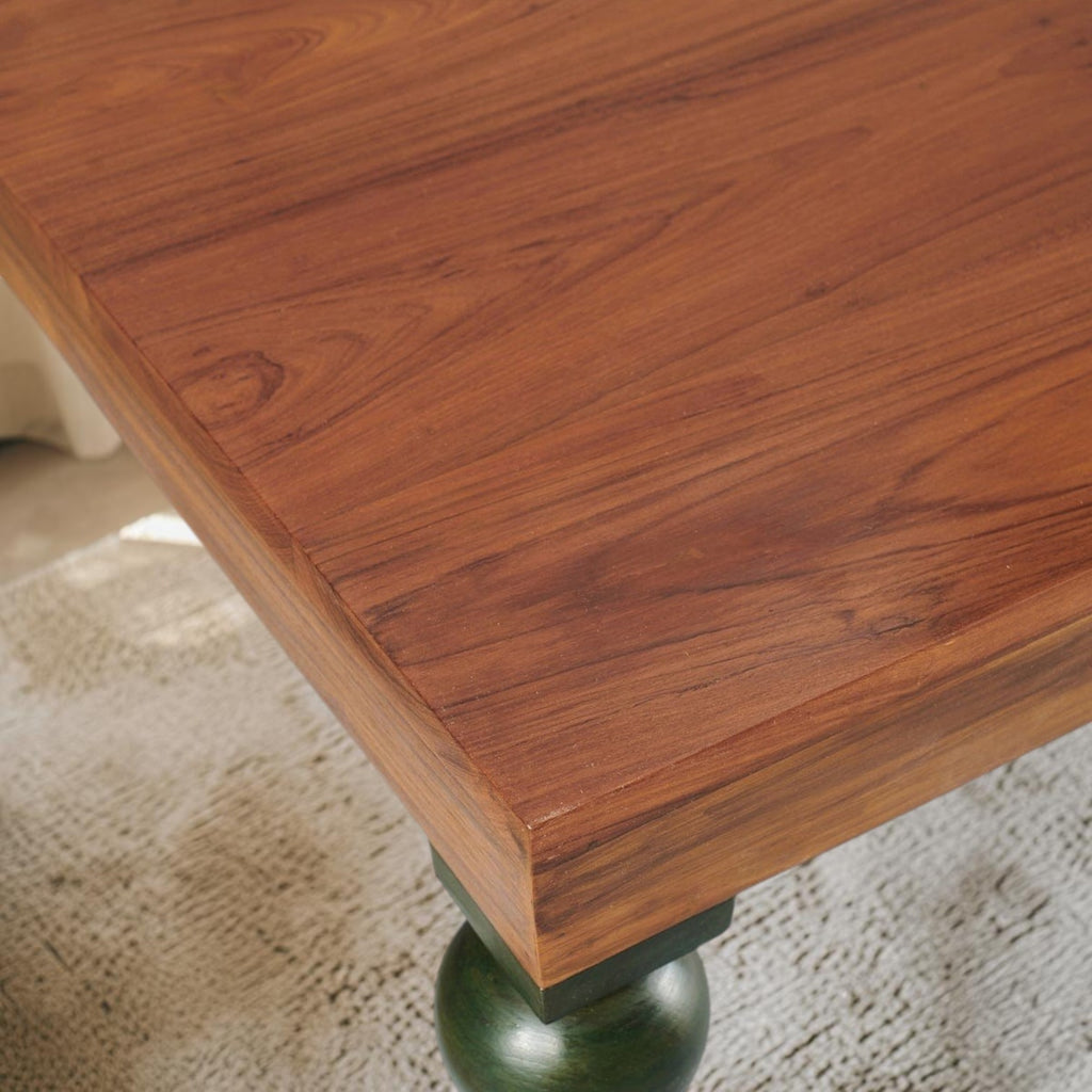 Homecrest Ellis rectangular dining table made of seasoned teak wood with a natural finish and teal accent leg detail.