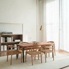 Homecrest Ellis rectangular teak dining table with natural wood top and teal legs, set with six wooden chairs.