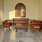 Homecrest Fairlight sheesham wood sofa set with slatted backrests and upholstered cushions in a sunlit living room