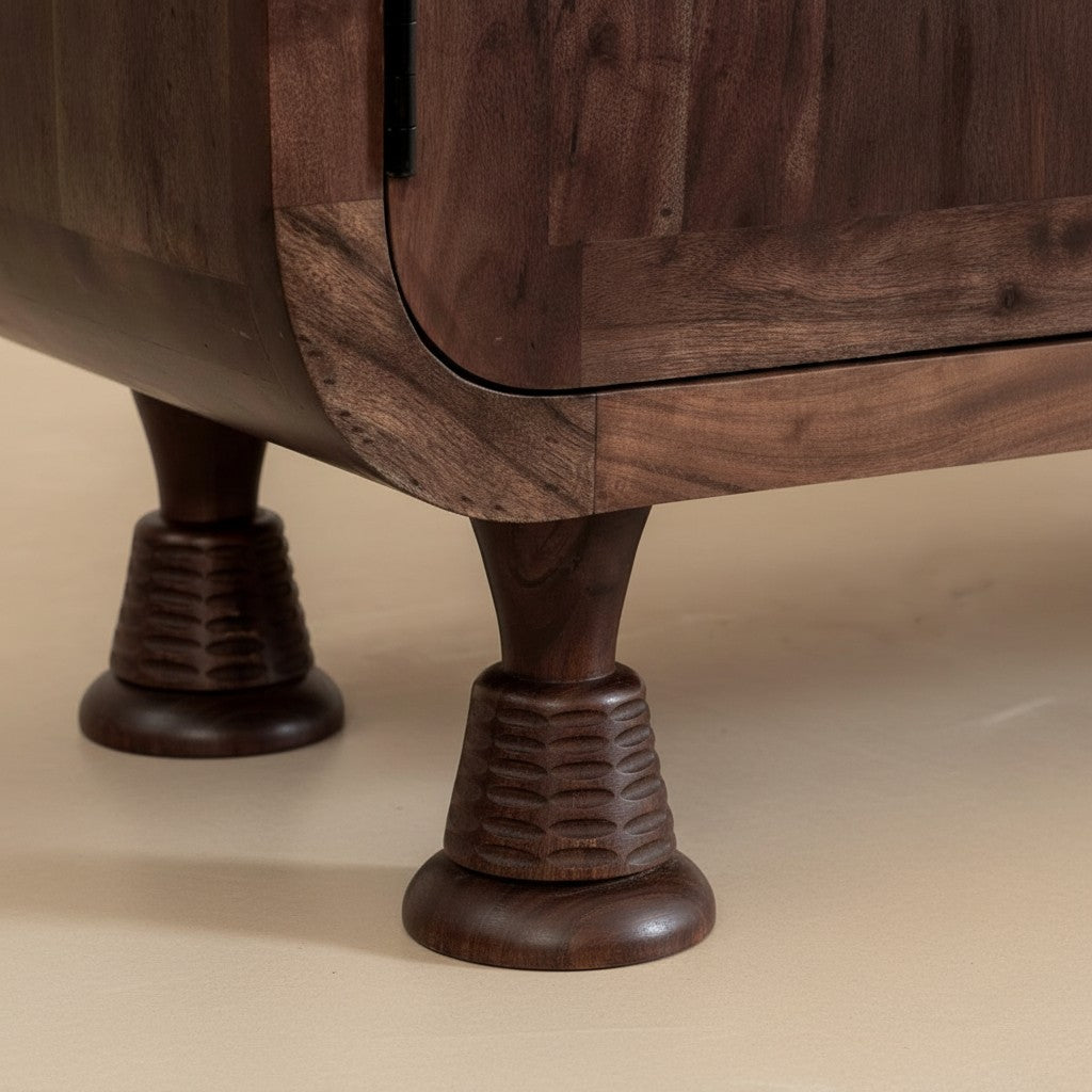 Homecrest Fairholm walnut acacia wood sideboard featuring unique carved pedestal legs and contoured cabinet base.