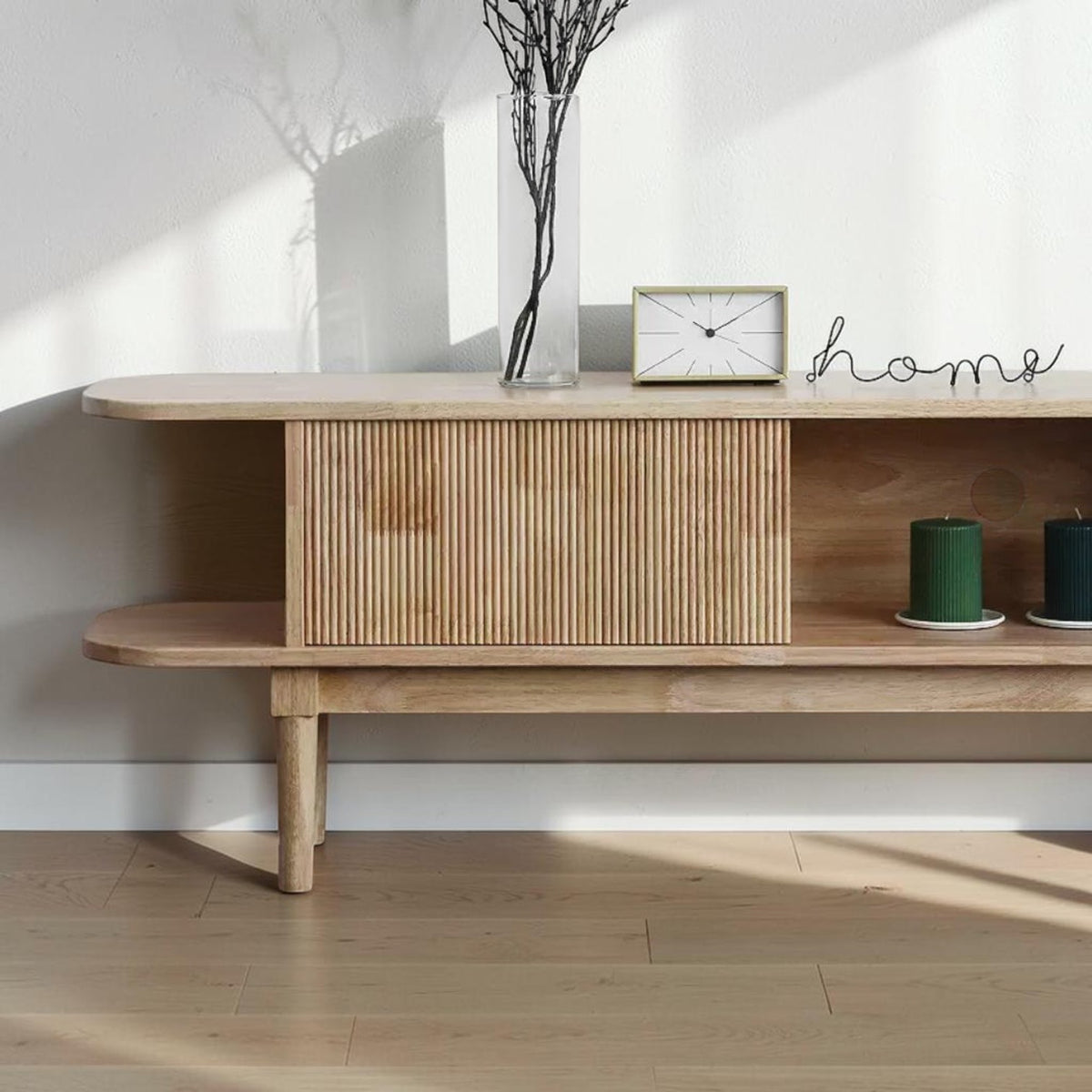 Homecrest Fallow media cabinet in natural mango wood with a fluted sliding door and minimalist rounded edges.