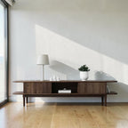 Homecrest Fallow media cabinet in walnut mango wood with fluted sliding doors and open shelving in a bright room.