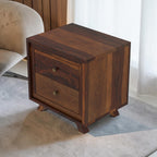 Homecrest Piera dark sheesham wood bedside table with two drawers, brass knobs, and tapered legs in a bedroom setting.