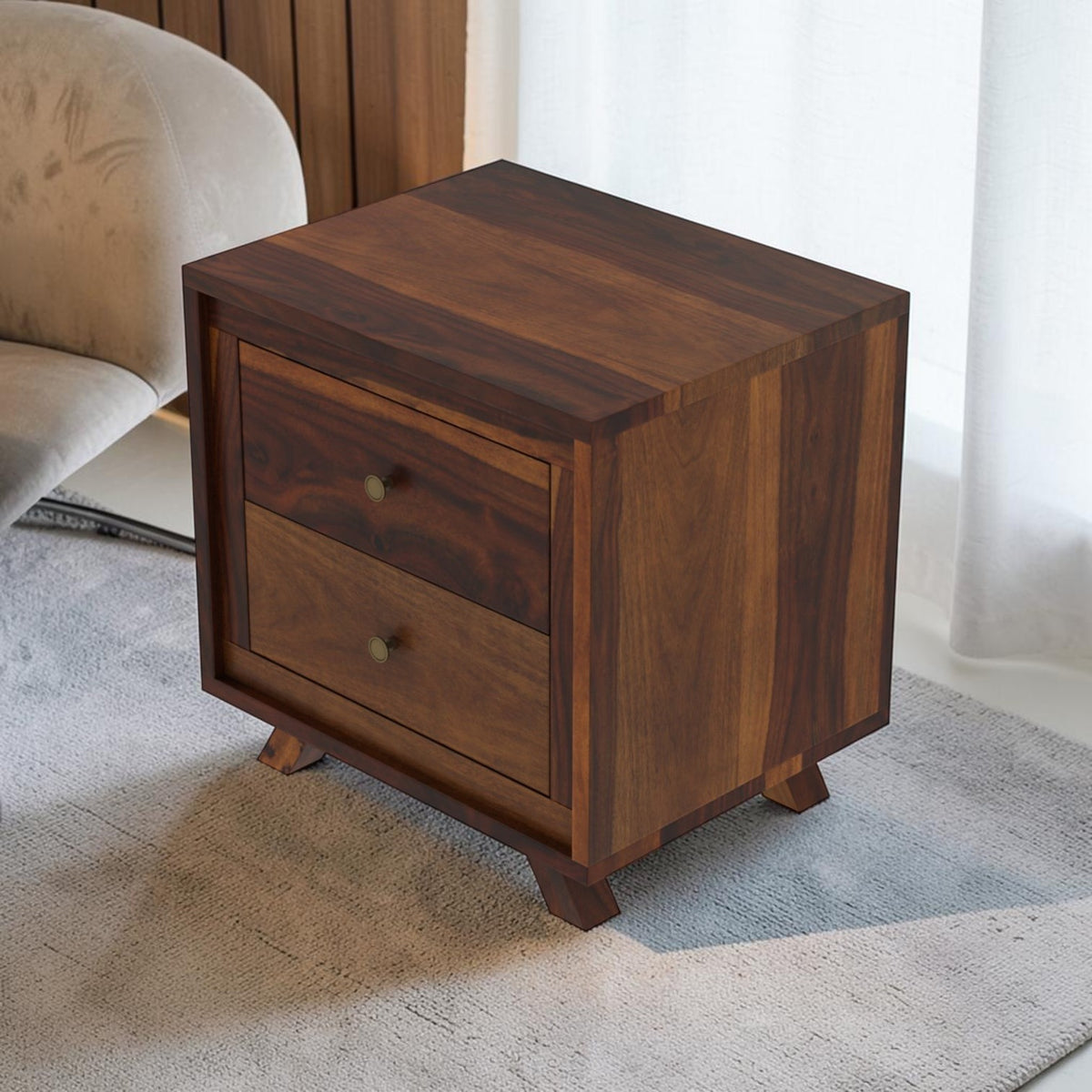 Homecrest Piera dark sheesham wood bedside table with two drawers, brass knobs, and tapered legs in a bedroom setting.