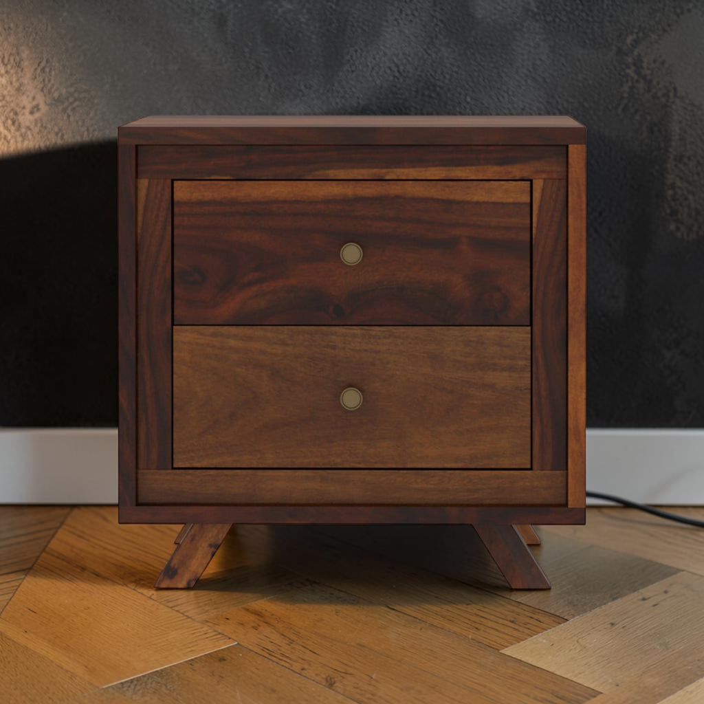 Homecrest Piera mid-century bedside table in dark sheesham wood with two drawers, brass knobs, and tapered legs.