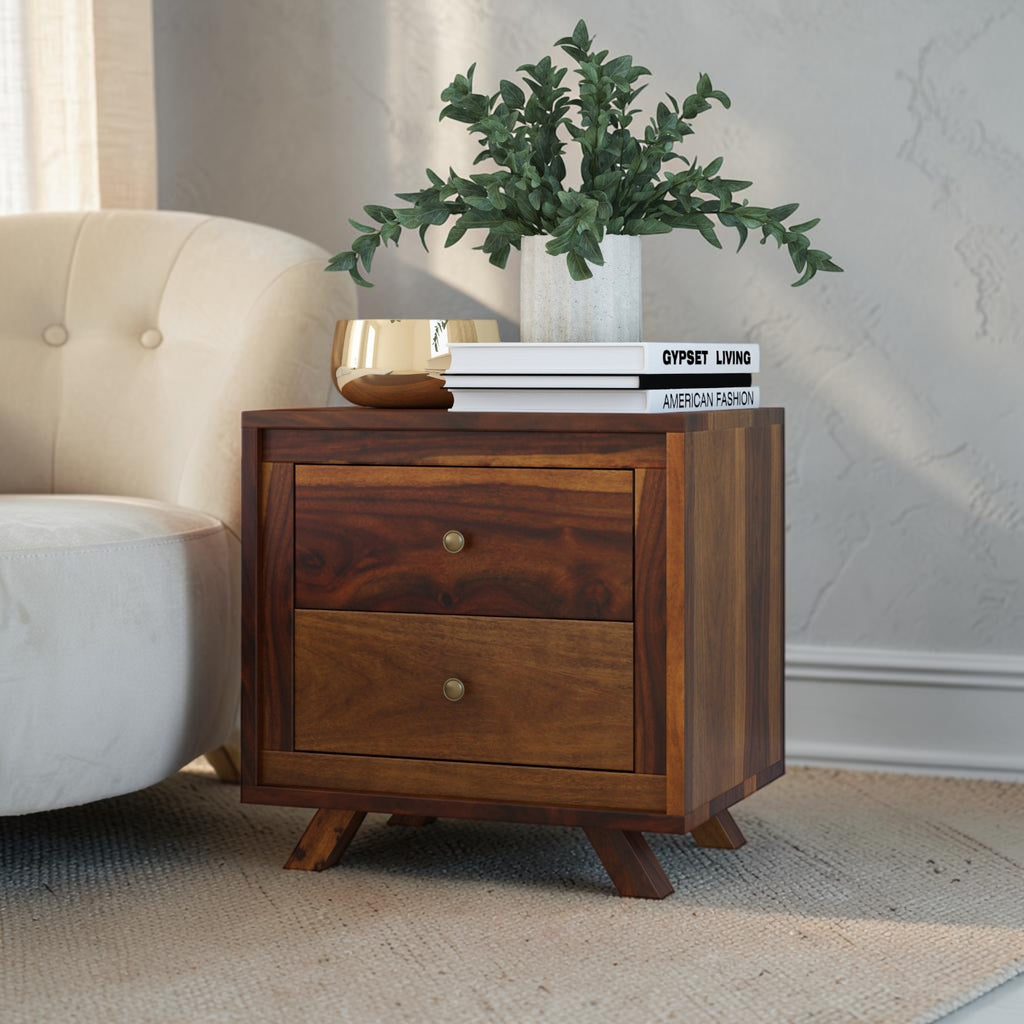 Homecrest Piera mid-century bedside table in sheesham wood with two drawers, brass knobs, and tapered block legs.