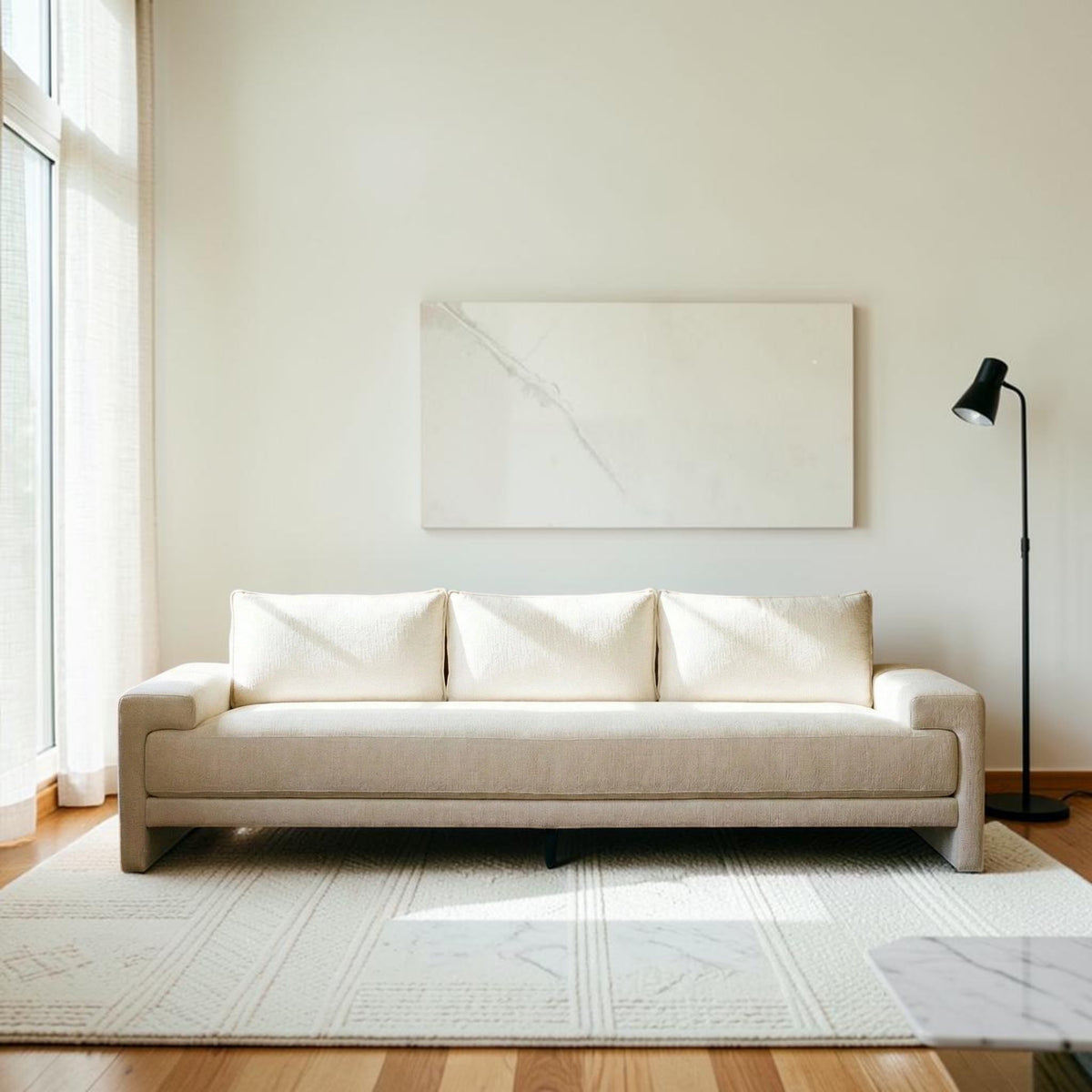 Homecrest Framlingham three-seater sofa in white cotton linen fabric against a rustic wall with a vintage rug