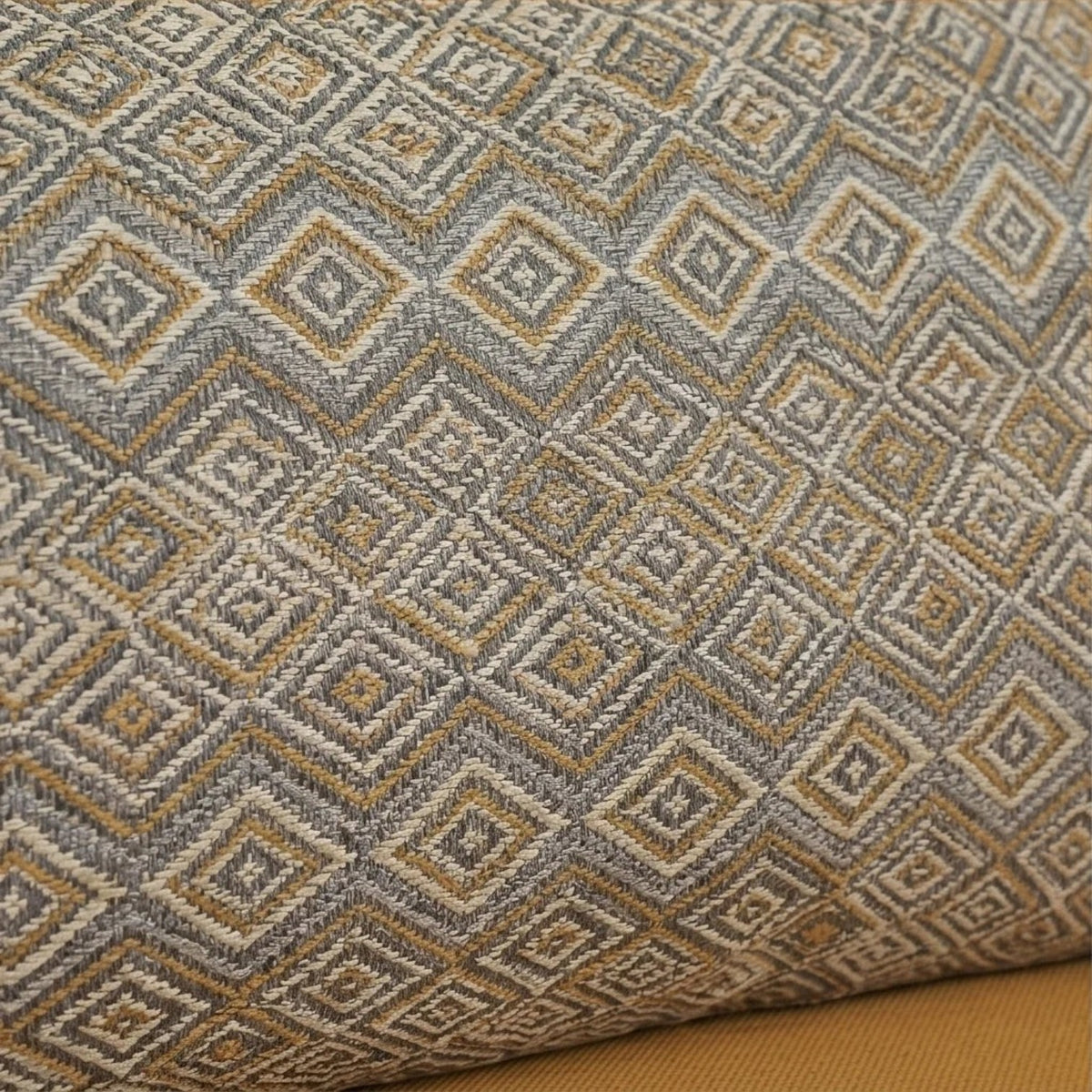 Homecrest sofa cushion featuring a textured grey and mustard yellow geometric diamond pattern fabric