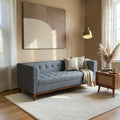 Homecrest 3-seater sofa in grey fabric with a tufted back and natural solid wood frame in a modern living room.