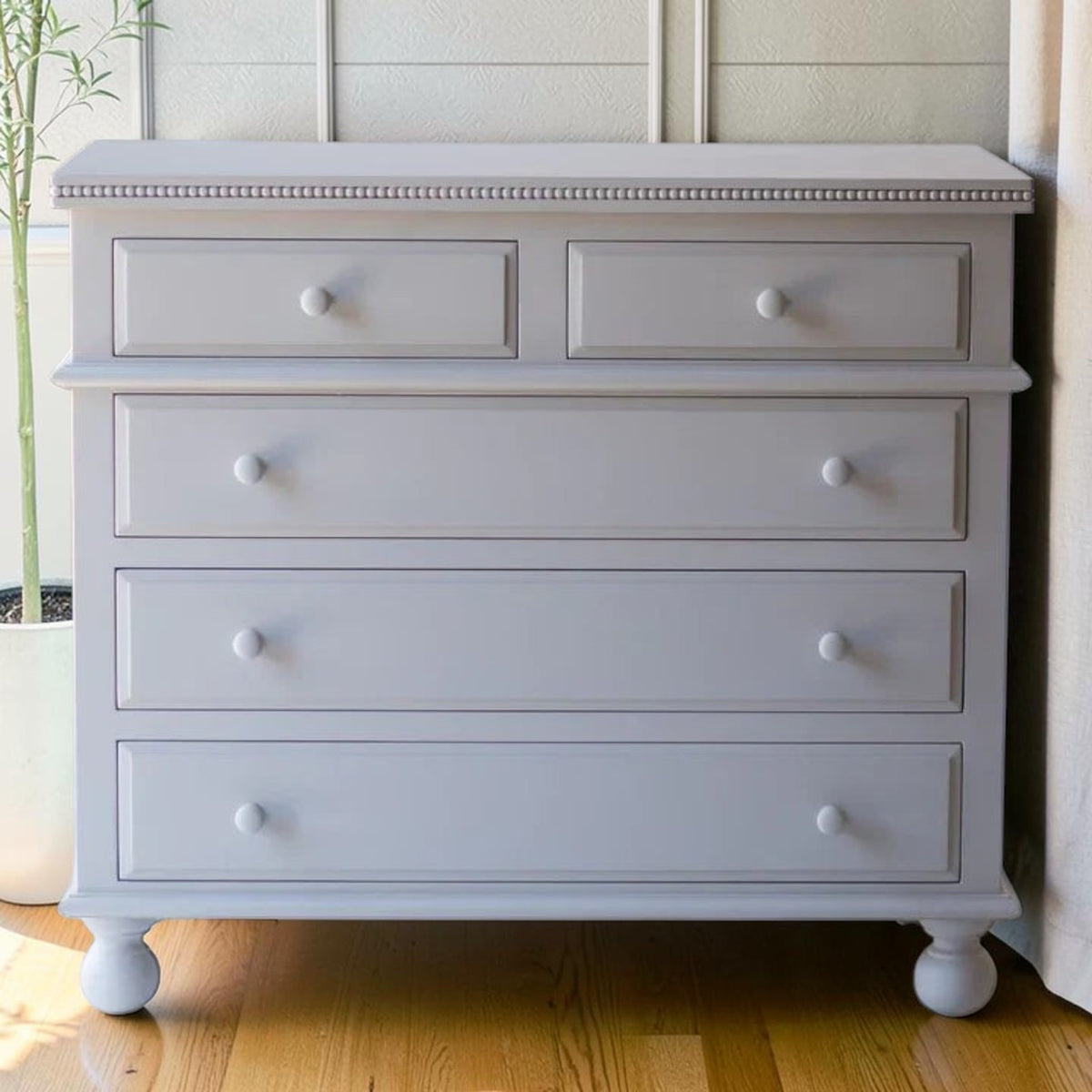 Homecrest grey solid mango wood five-drawer chest with beaded moulding and classic bun-foot legs.